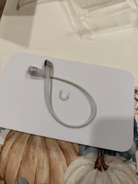 a white box with a cable attached to it